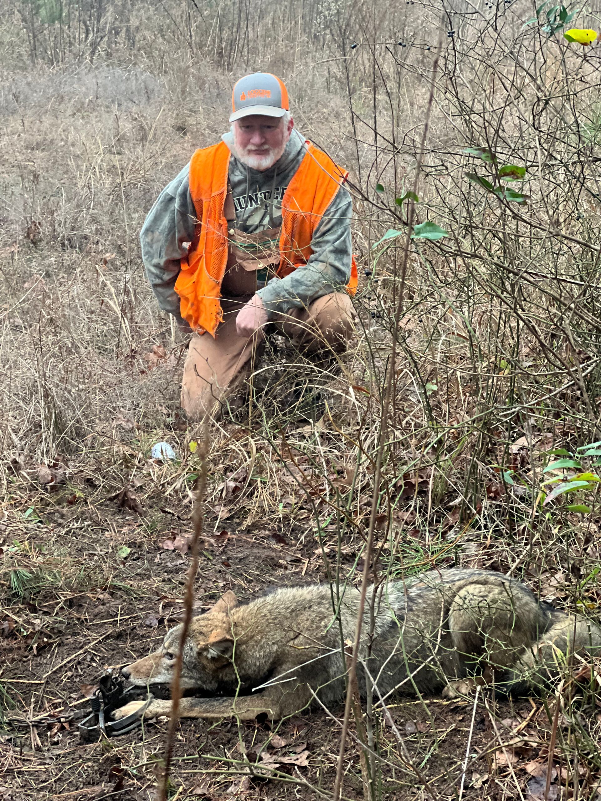 Predator Control Jeremy with trapped coyote during removal job in Arkansas