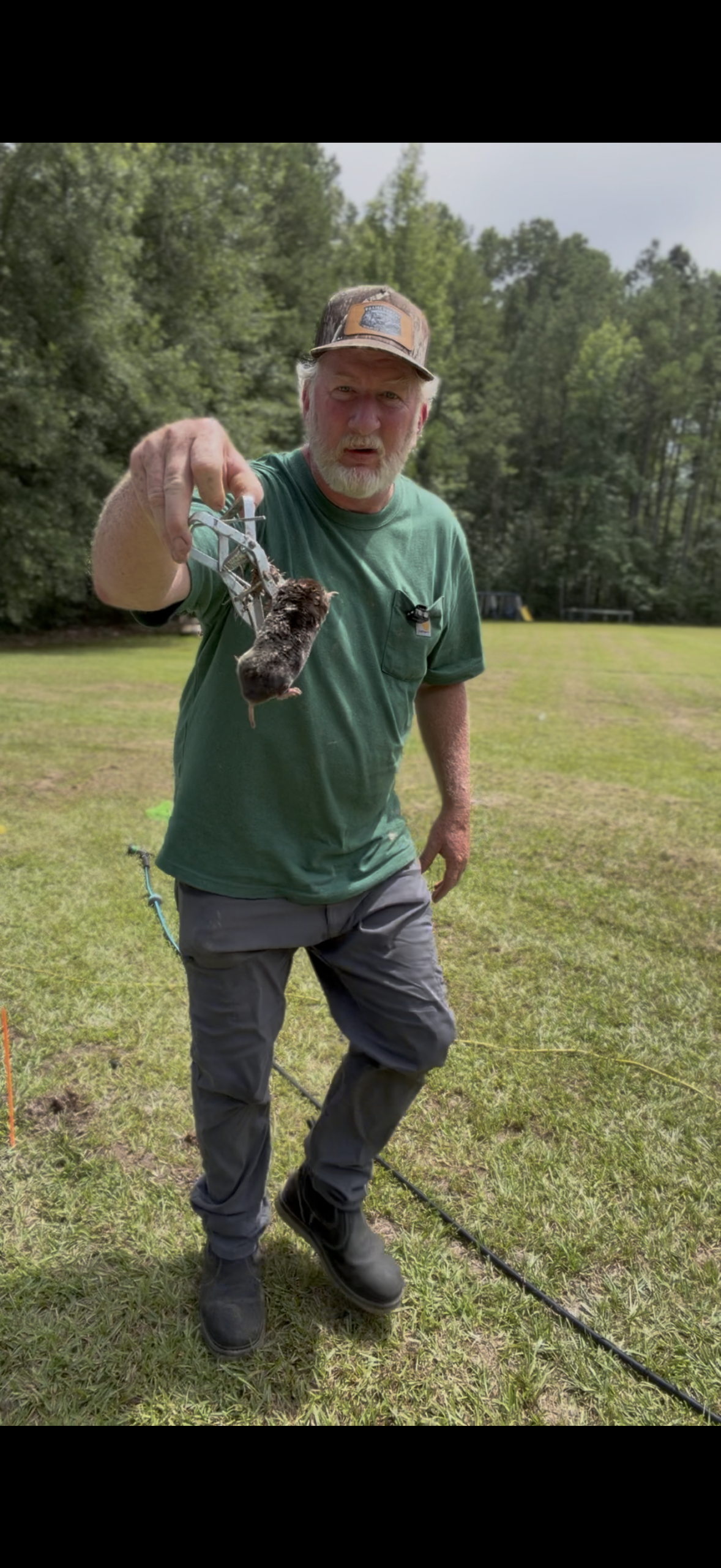 Jeremy Bass holding trapped mole during removal job in Arkansas – Praiseworthy Wildlife Solutions